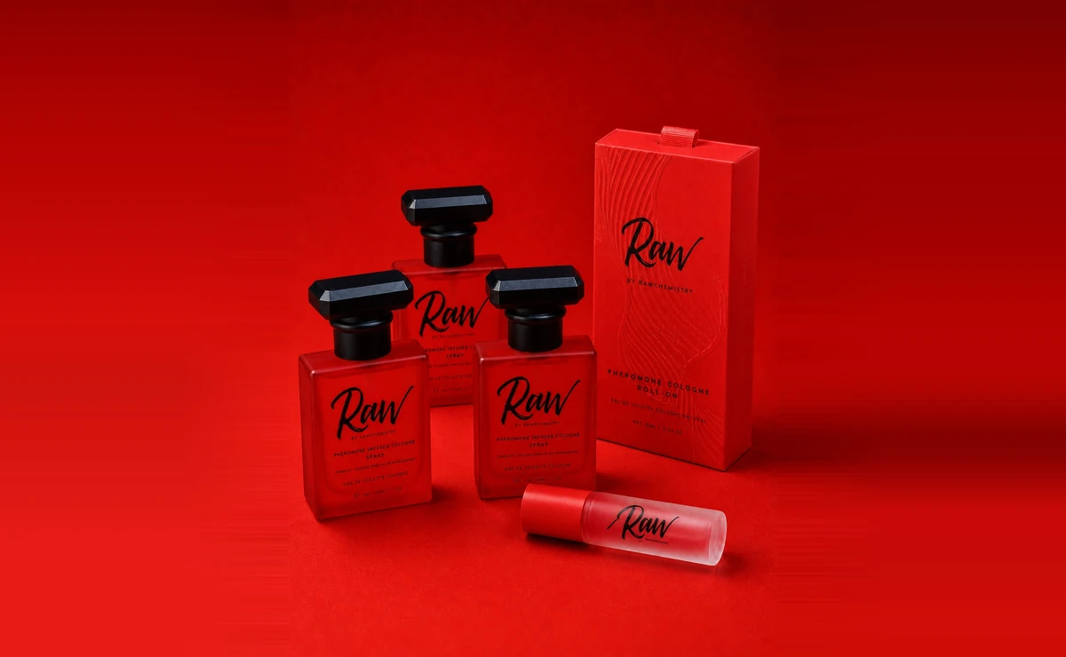 Three full-size RAW Chemistry pheromone cologne sprays beside the complimentary RAW roll-on and its carton