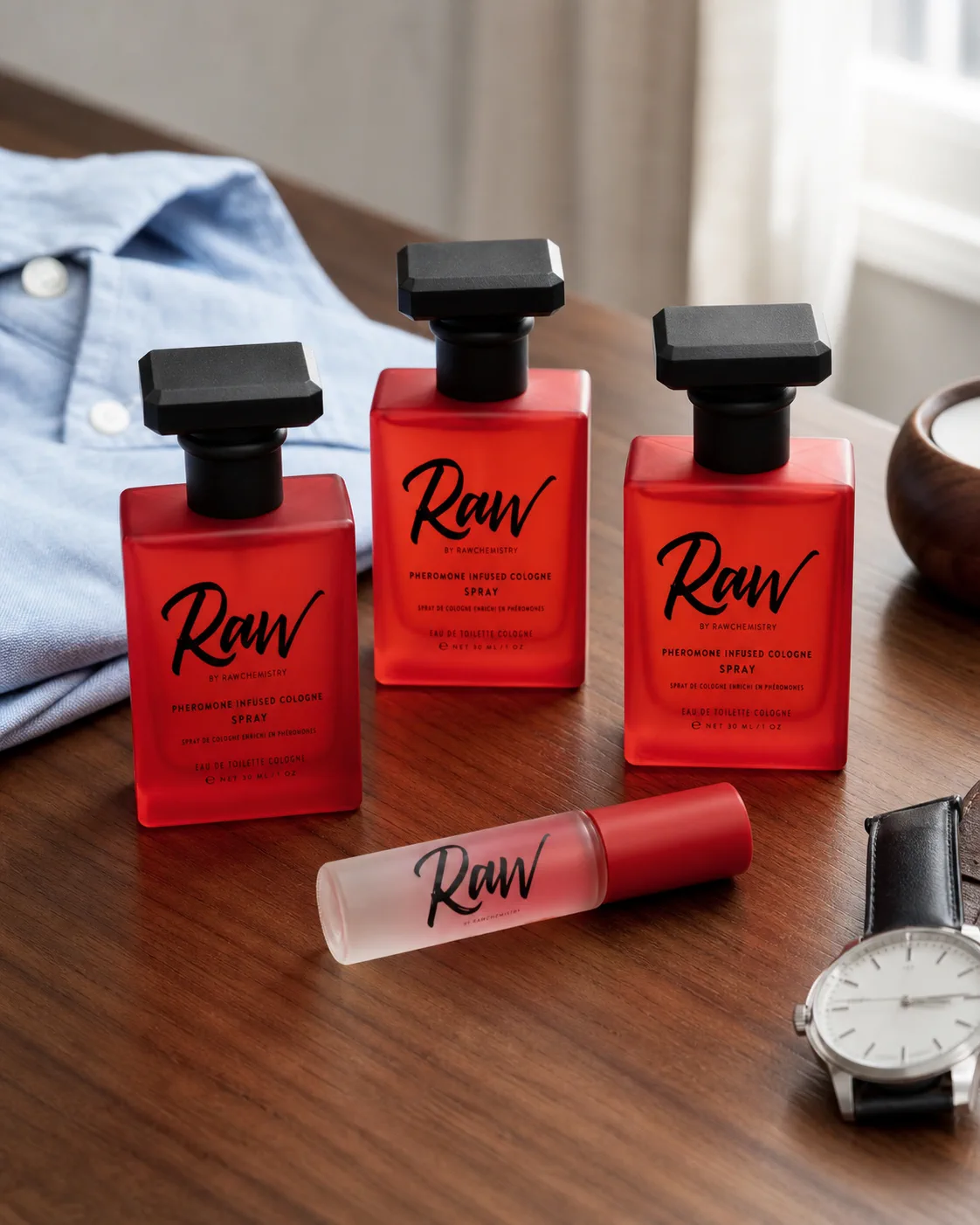 Three full-size RAW sprays and one travel roll-on arranged together in daylight
