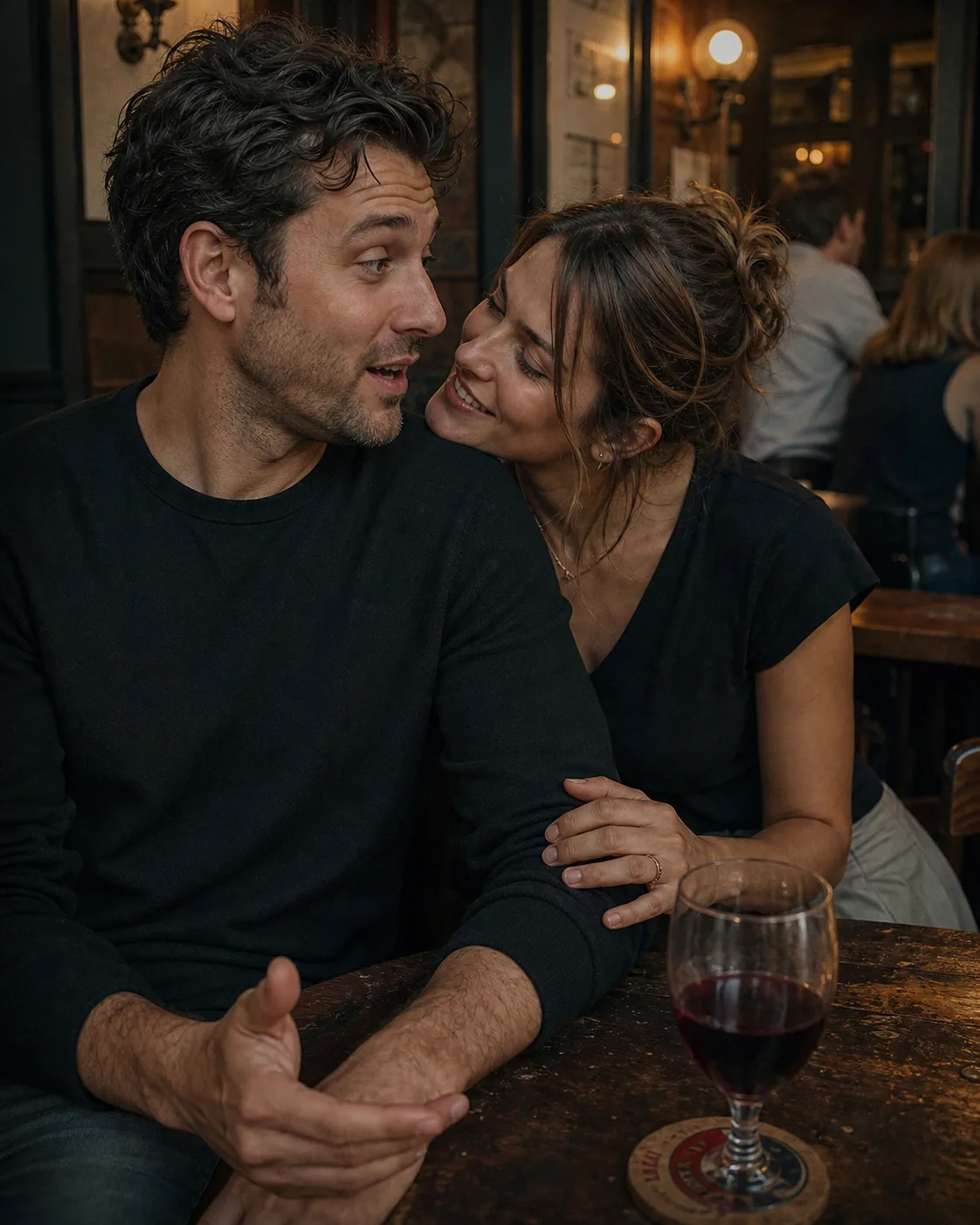 Woman leaning close to a man during a conversation at a neighborhood bar