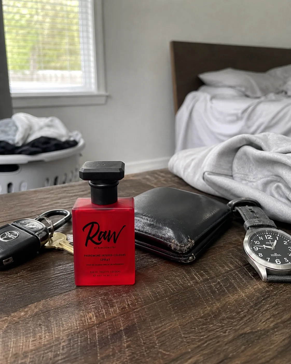 RAW bottle on a lived-in dresser beside keys, wallet and watch