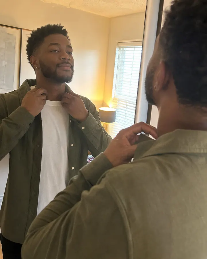 A man smiling before a social outing