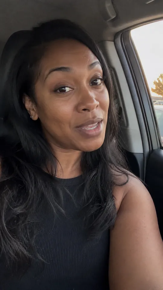 Woman in a car sharing her reaction to the scent