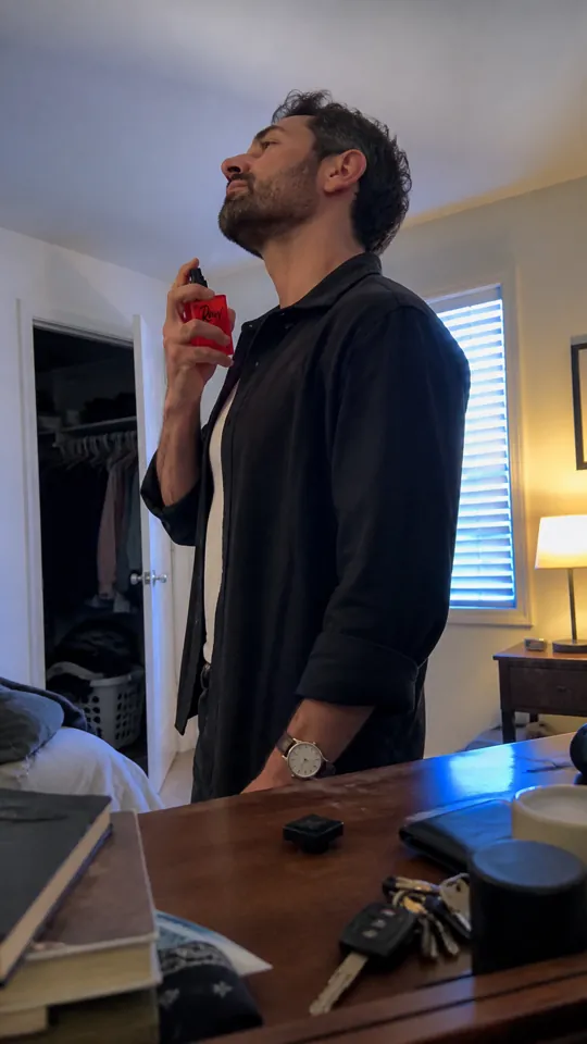 Man spraying RAW before leaving his bedroom