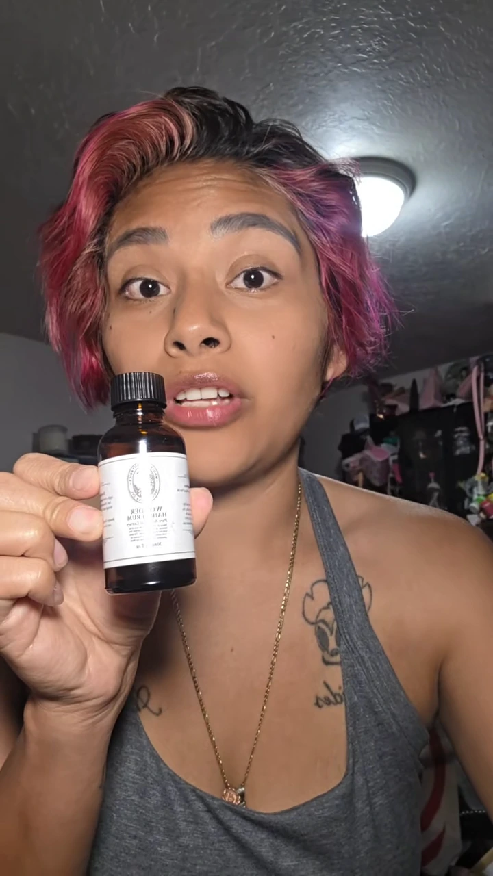 Yoazin holding the Wonder Hair Serum bottle in her original product walk-through